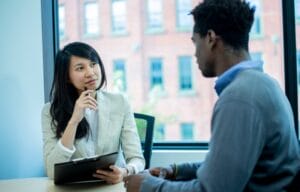 two people at work talking